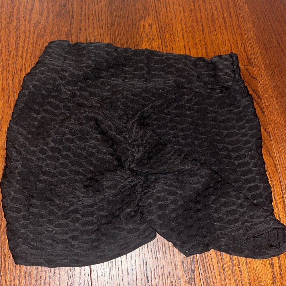 Black short workout shorts, cinched in the back